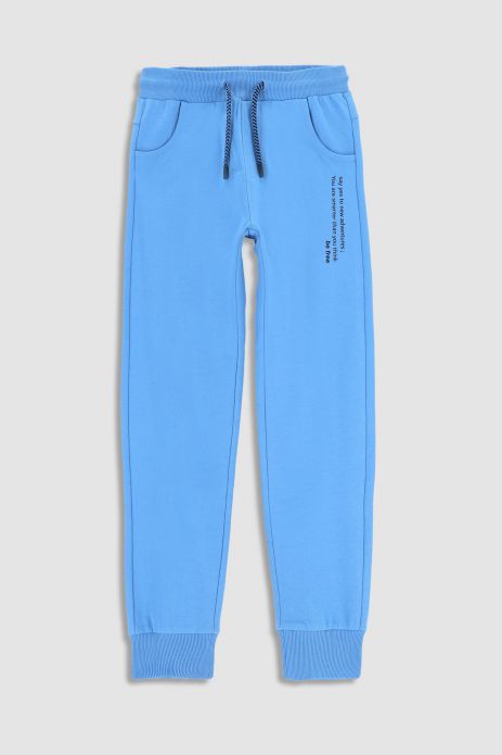 Teplákové nohavice modré s nápismi na nohavici, strih REGULAR